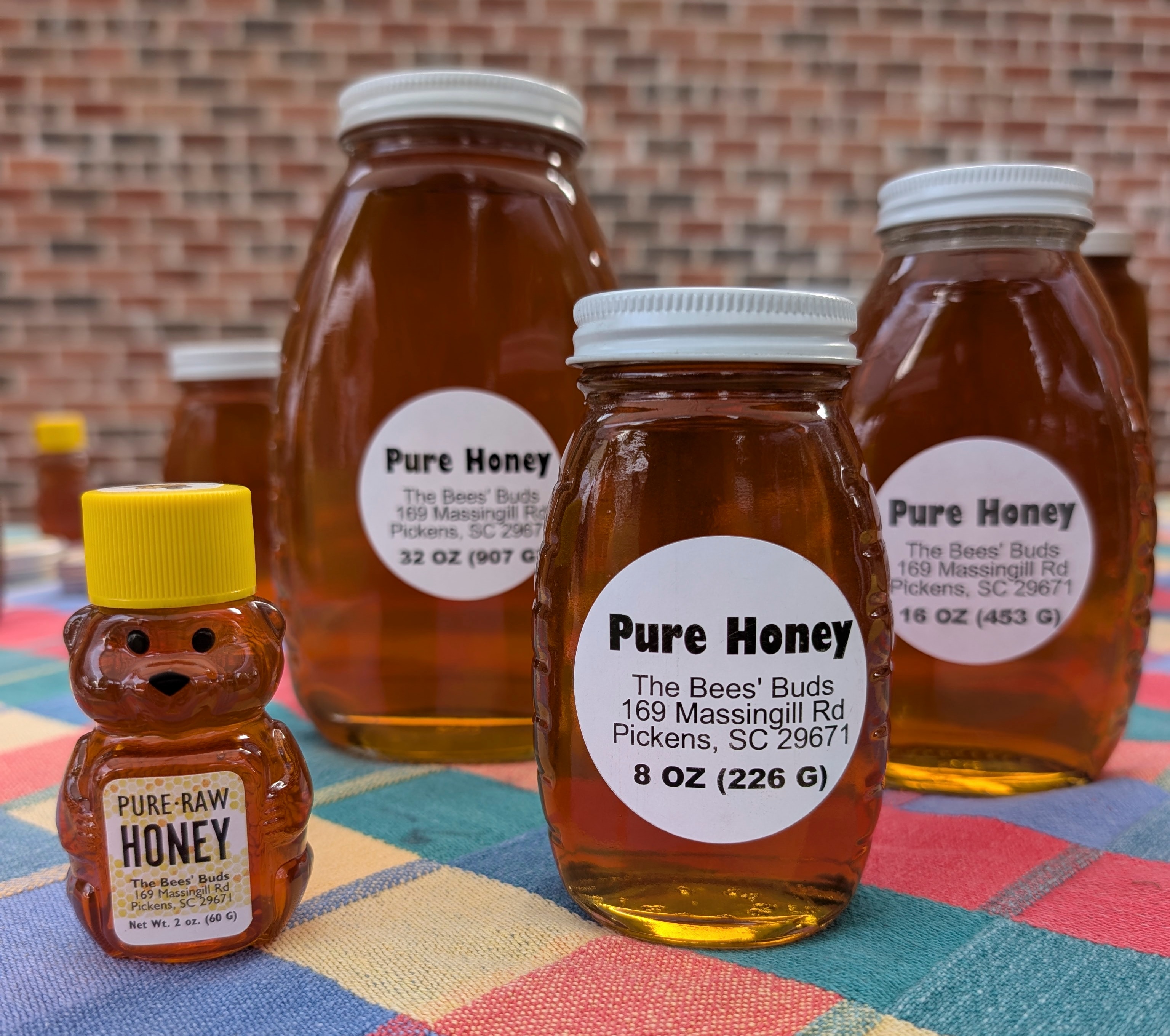The Bees Buds honey jars — various sizes of raw wildflower honey